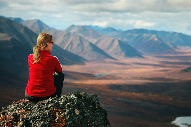 person looking out on a mountain range