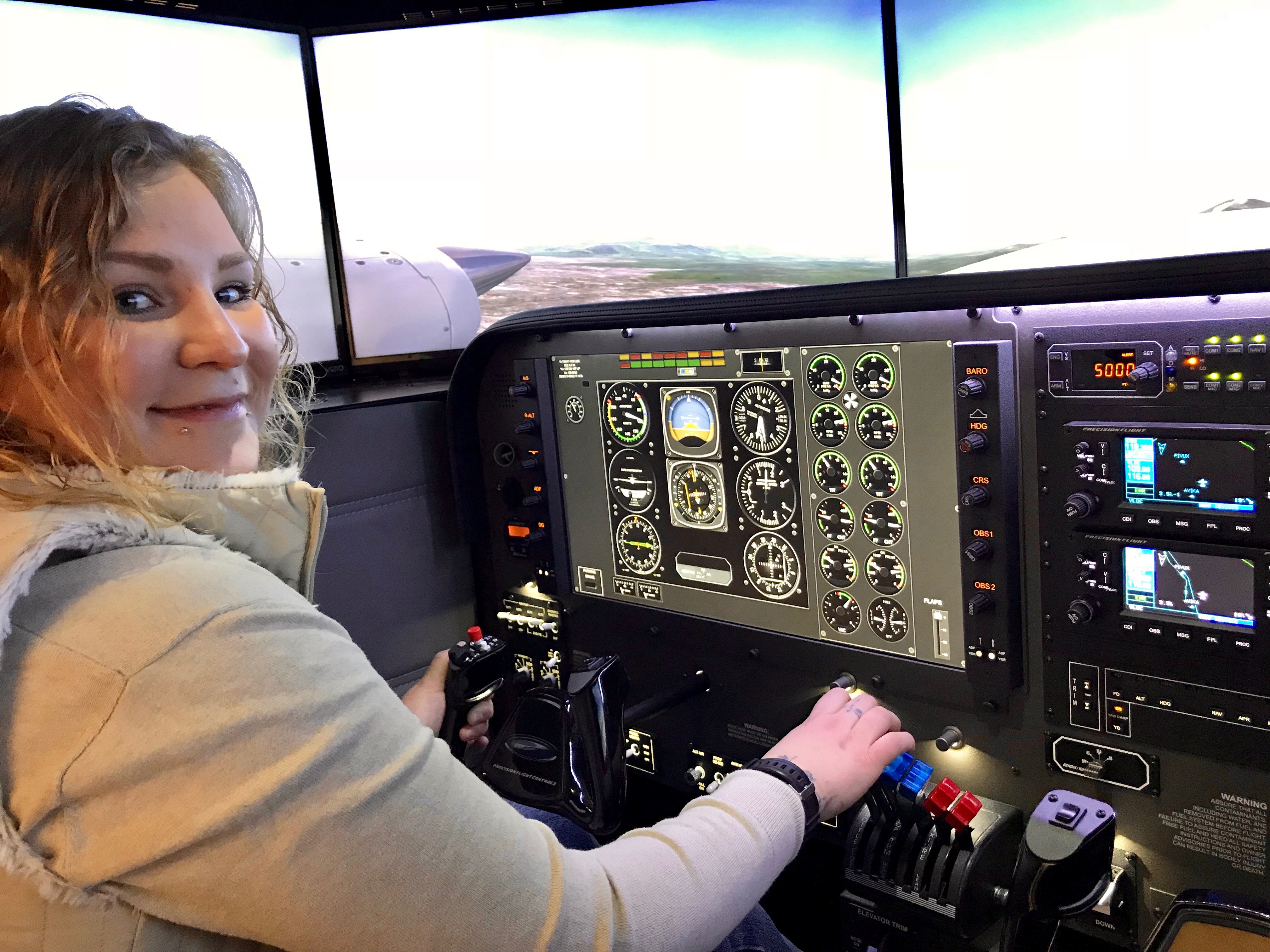 Helina TenHoeve, Aviation Management Diploma student tests out the new flight similator