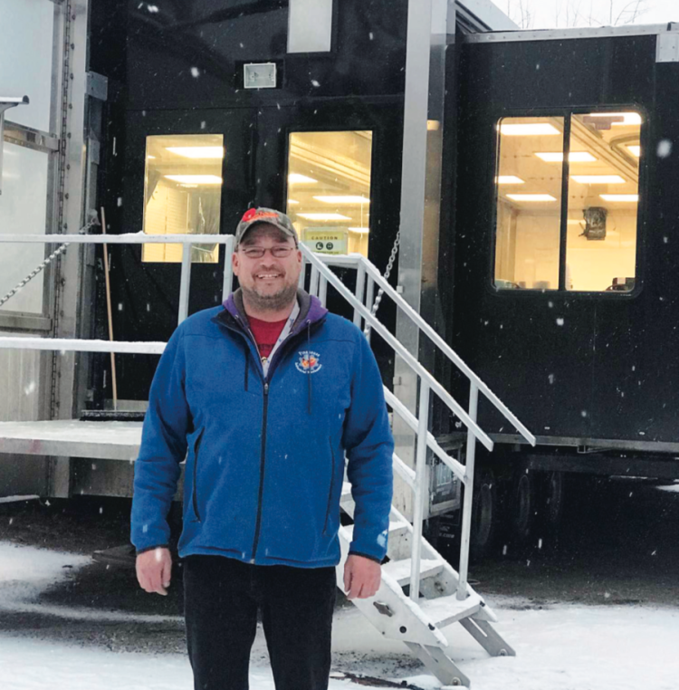 Transition Support Coordinator and Instructor Jim Pope with the Mobile Trades Training Trailer in Pelly Crossing, Yukon.